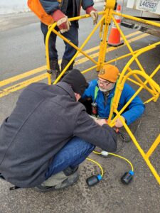 Descending into manhole to install sewer overflow sesnor